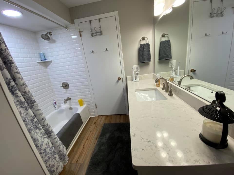 Remodeled bathroom with subway-tile tub surround and quartz vanity by Stark Elite Home Solutions in Massillon, OH