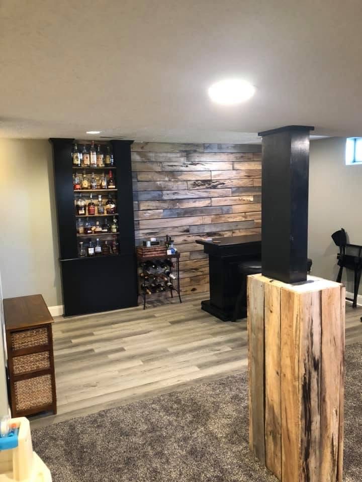Garage converted to modern living space with bar and reclaimed wood feature wall in Northeast Ohio